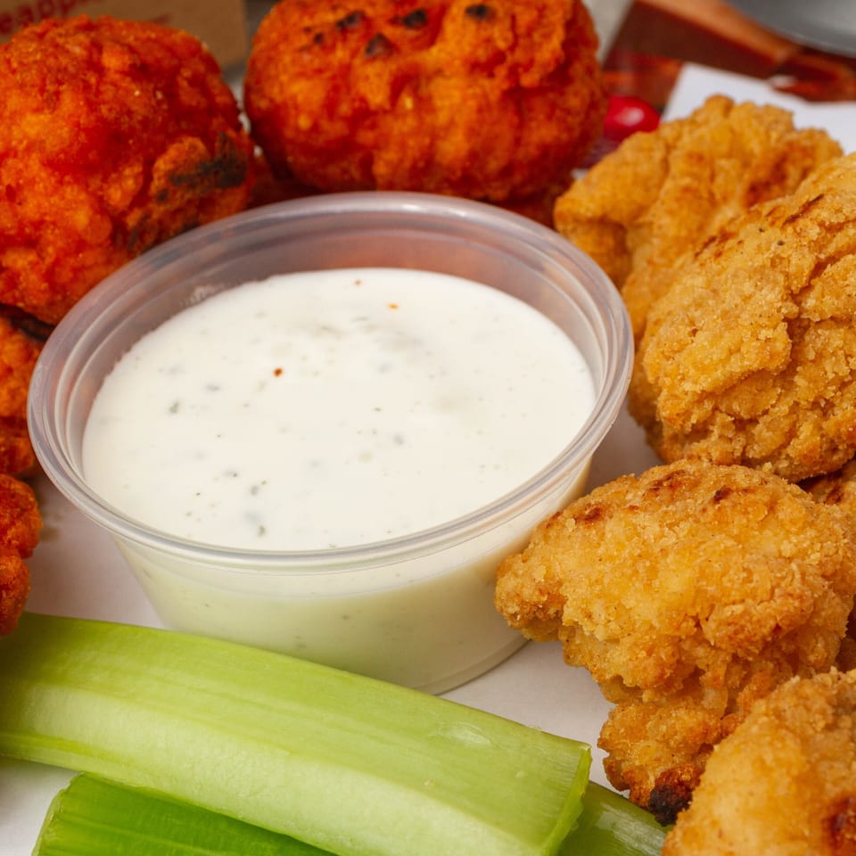 Rounders Pizza's fried chicken and buffalo chicken bites with ranch dressing and celery sticks.